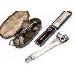 An Art Deco period continental silver handled cigar cutter, together with a 15ct gold marked stick
