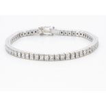 An 18ct white gold diamond line bracelet, the fifty nine princess cut diamonds in an articulated