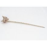 A 9ct gold fox head and ruby eyed stick pin, 6.5cm, 2.7g