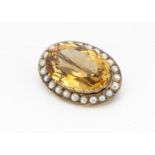 A 9ct gold citrine and pearl bezel oval brooch, the claw set citrine with crown gallery and half