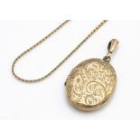 A 9ct gold oval locket with central heart cartouche, marked to bottom of oval, 4.2cm including