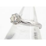 An 18ct gold diamond solitaire, the brilliant cut in eight claw setting on crown gallery with scroll