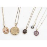 A collection of 9ct gold pendants, including lockets, ruby and diamond heart pendant, cameo pendant,