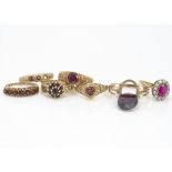 A collection of seven garnet set dress rings, some with vacant settings, one with missing claw,