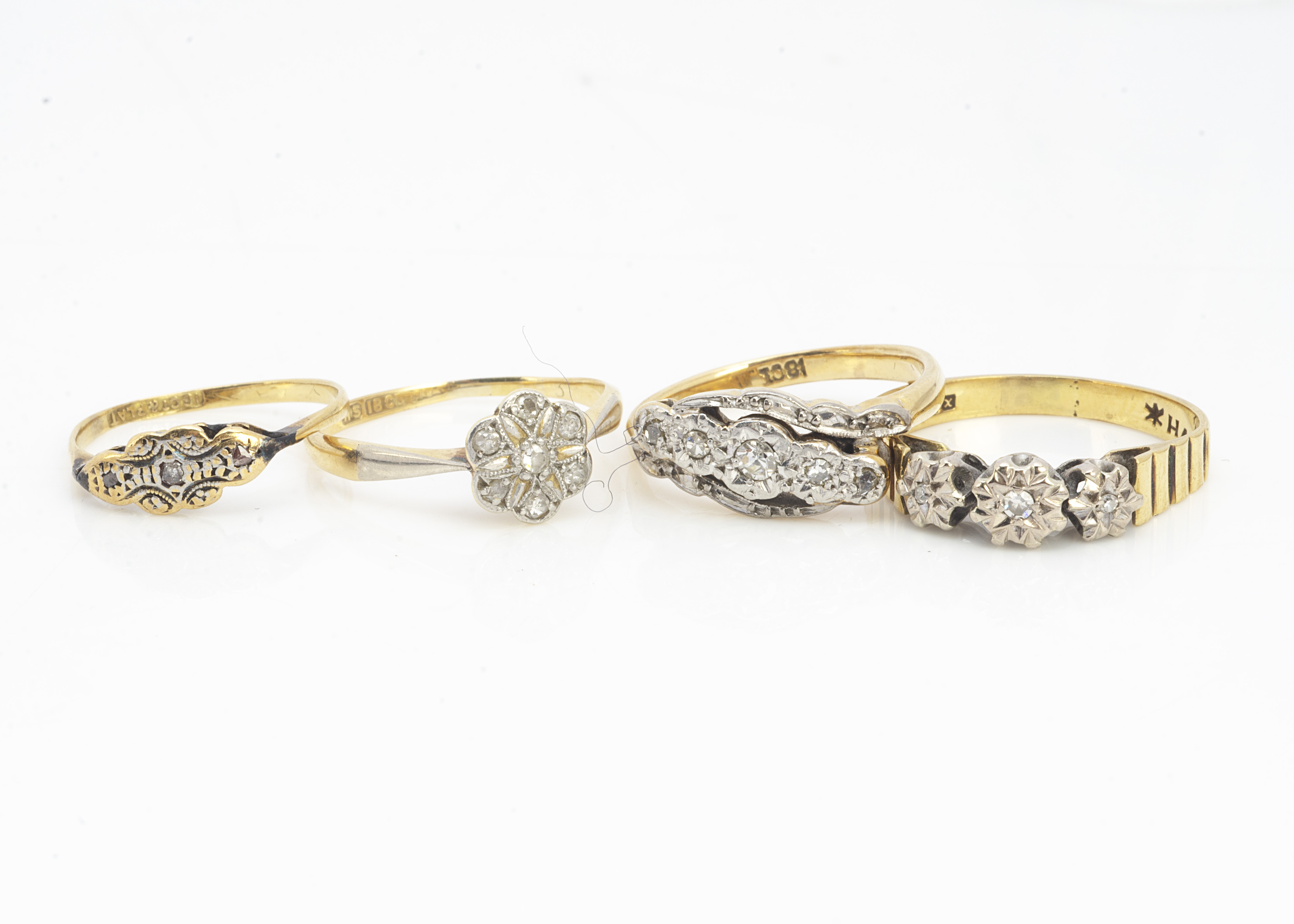 A collection of four diamond set dress rings, all in 18ct, various types and styles of settings, 9.