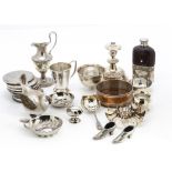 A collection of silver plated items, including a pair of small shoe pin cushions, an Egyptian plate,