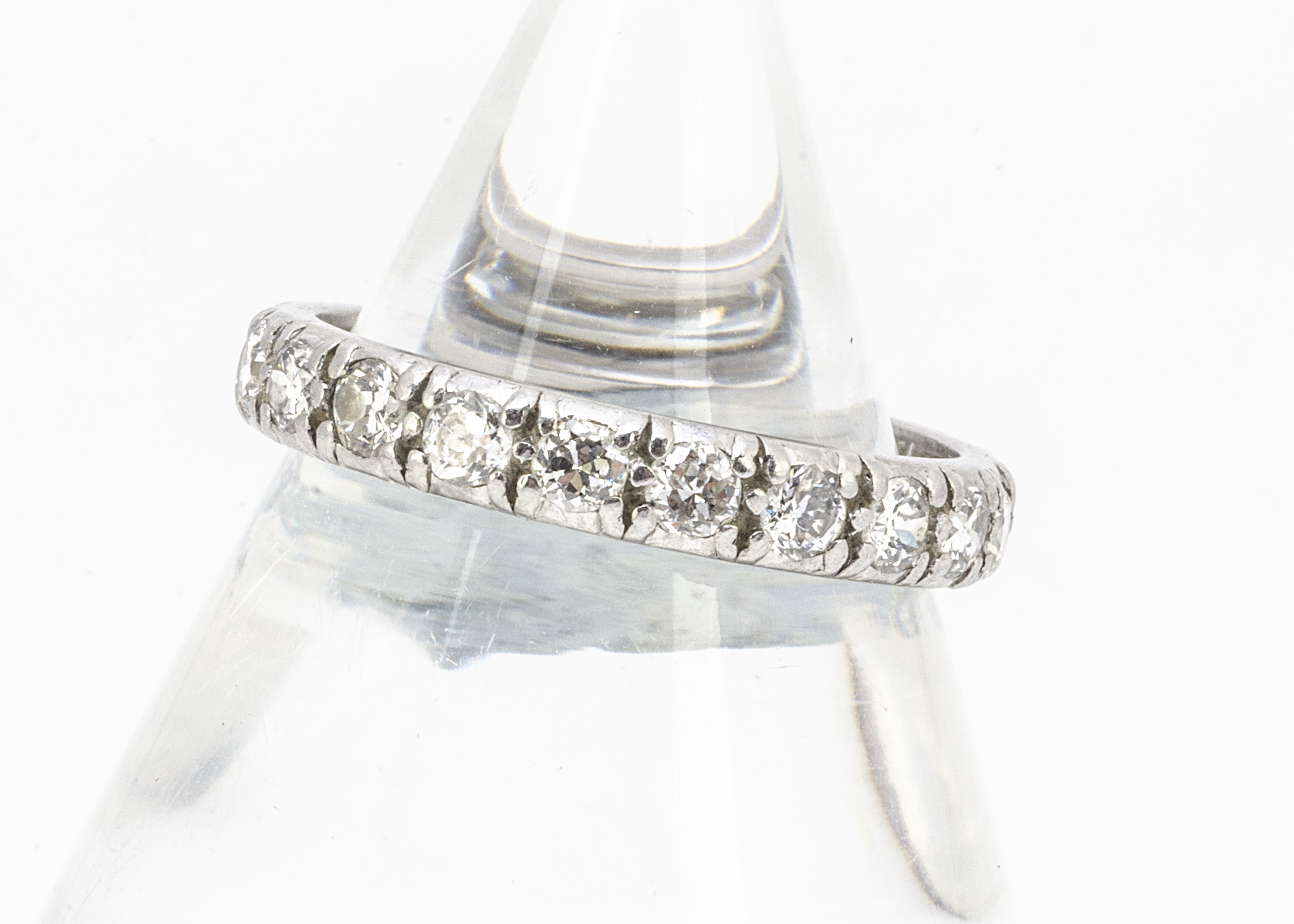 A diamond full eternity band, in white metal, old cut stones in raised claw settings, ring size P,