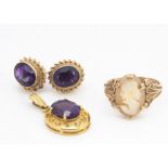 An amethyst 9ct gold drop oval pendant, a pair of 9ct gold and amethyst stud earrings and a shell