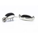 Two Edwardian period silver novelty pin cushions, one in the form of a wheel barrow, 7cm, the