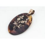 An Edwardian pique work oval pendant, with floral decoration and plain bale marked 9ct, 5cm x 3.2cm,