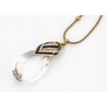 A 19th Century continental rock crystal and enamel pendant and fine gold chain, the oval rock