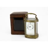 A late 19th Century brass carriage timepiece, oval form, glass panels loose, appears to run, with