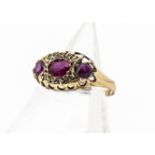 An Edwardian ruby and diamond dress ring, the three mixed cut rubies, in an oval shaped setting