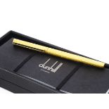 A Dunhill roller ball pen, gilt with black panel to clip, in box