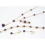 An Edwardian 15ct gold amethyst and seed pearl suite of jewels, comprising a necklace with drop