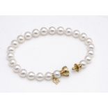 A boxed Mikimoto 18ct gold diamond and cultured pearl bracelet, the white pearls with pink overtones