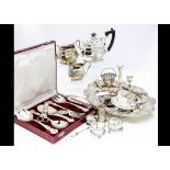 A collection of silver plate, including a three piece tea set, a meat dish, a double wine bottle