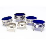 Three pairs of George III silver salts, twin oval pierced neo-classical, one with blue glass liners,