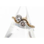 An 18ct gold and platinum set old cut diamond crossover ring, each stone approximately 0.40ct, in