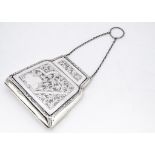 An early 20th Century silver purse by EDL, hinged and having engraved designs, 5.5ozt, with brown