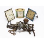 An Art Deco enamelled travel timepiece, AF, together with two further travel clocks and an OXO tin