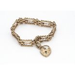A 9ct gold three bar gate link bracelet, with heart shaped padlock clasp, with safety chain, 18cm