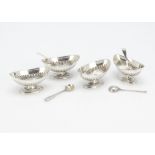 A set of four Victorian silver table salts, each elliptical half fluted bowl on oval bases, together
