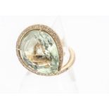 A large bespoke 18ct gold diamond and prasiolite dress ring, the pear shaped central green stone