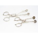 Two pairs of antique silver sugar tongs, one Georgian pair with initials MA, 11cm, the other pair of
