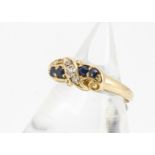 An 18ct gold sapphire and diamond Edwardian dress ring, the pairs of blue sapphires either side of