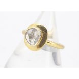 A contemporary silver gilt and diamond slither dress ring, the rubbed over diamond setting on a