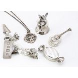 A silver charm bracelet, with various applied charms including a large domino ingot, an Irish