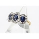 A triple cluster sapphire and diamond dress ring, set in white gold claw settings on a yellow