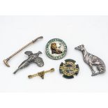 A collection of field sports badges and brooches, including a 9ct gold riding crop bar brooch, a