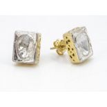 A pair of silver gilt and diamond slither stud earrings, in rubbed over settings of rectangular