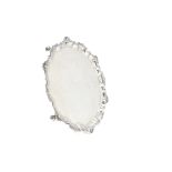 A 1970s silver salver from Mappin & Webb, having shaped edge with shell and egg and dart decoration,