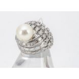 A 14ct white gold diamond and pearl bombe shaped dress ring, the cultured pearl upon an oval setting