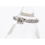 A GIA certificated diamond engagement ring, the brilliant cut in four claw setting with graduated