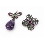 An amethyst, emerald and ruby set pendant, the tear shaped amethyst bead supported on a bow mount