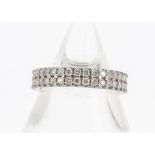 An 18ct gold double diamond band eternity ring, the claw set brilliant cuts all in white gold,