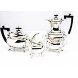 A George V silver four piece tea set by Walker & Hall, comprising teapot, hot water, sugar basin and