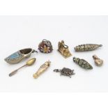 A miscellaneous collection of gold and silver charms, including a seed pearl and blue enamel heart