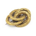 A Victorian gilt metal knot brooch, with intertwined rope and bead decoration, base metal pin, later