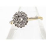 An Edwardian old cut diamond platinum and 18ct gold daisy ring, the flower head in platinum