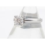 A certificated diamond set platinum solitaire, the brilliant cut in four claw raised setting, with