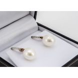 A pair of cultured pearl and diamond drop earrings, with Omega fastenings, 2.5cm drop, boxed,