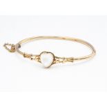 A 15ct gold moonstone set hinged bangle, the heart shaped stone within a rope twist setting with