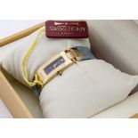 A contemporary 18ct gold and diamond set lady's wristwatch by Swiss Horn, the rectangular links