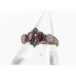 A Victorian garnet and paste ring, the oval mixed cut garnets set with green paste and opaque