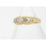 An 18ct gold diamond dress ring, the central round brilliant diamond in claw setting, with diamond